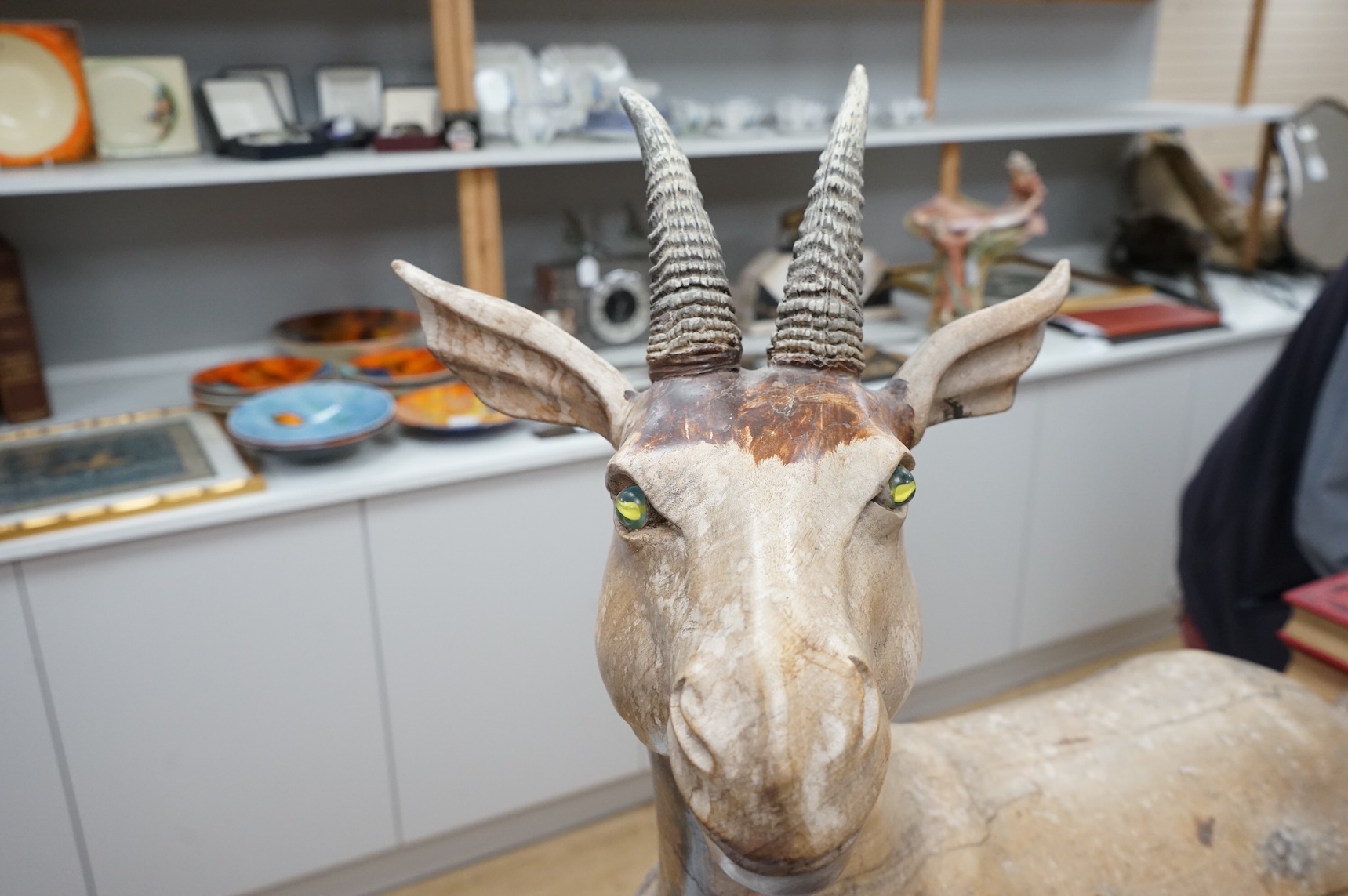 A large Vietnamese hardwood model of a recumbent goat, 78cm wide